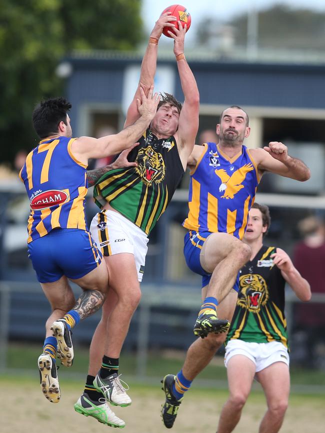 Dromana’s Jay Hutchinson gets his hands on the ball against Somerville.