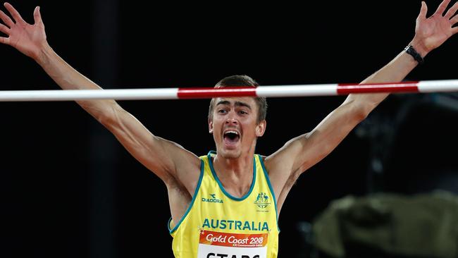 Australian high jumper Brandon Starc clears the bar on his way to the gold medal at Carrara Stadium last night. Picture: AFP