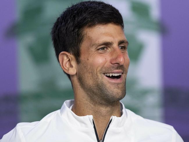 Serbia's Novak Djokovic smiles during the press conference following his defeat of Switzerland's Roger Federer in the men's singles final match of the Wimbledon Tennis Championships in London, Sunday, July 14, 2019. (Joe Toth, AELTC Pool Photo via AP)