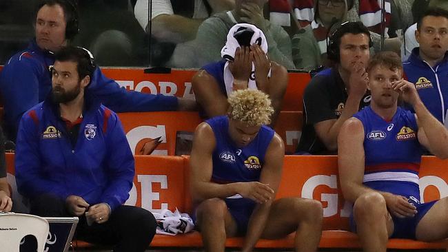 A devastated Lin Jong sits on the bench after injuring his knee. Picture: Michael Klein