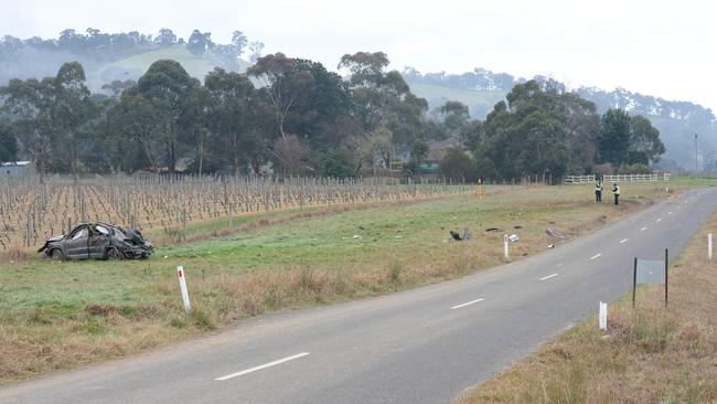 Police inspect debris from the car crash in Glenview Rd, Yarra Glen. Picture: Lawrence Pinder.