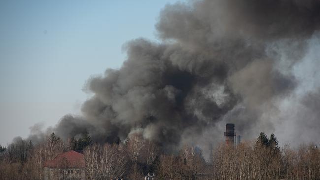 Smoke is seen above buildings close to the airport in Lviv, Ukraine. Picture: AFP