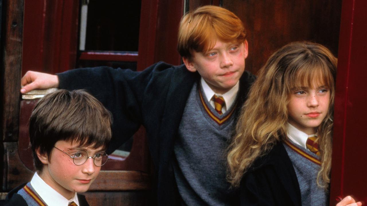 Daniel Radcliffe with Rupert Grint and Emma Watson in Harry Potter and the Philosopher's Stone.