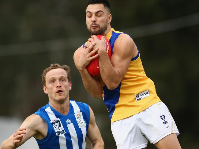 Michael Gibbons marks strongly against North Melbourne. Picture: Mike Owen/Getty Images