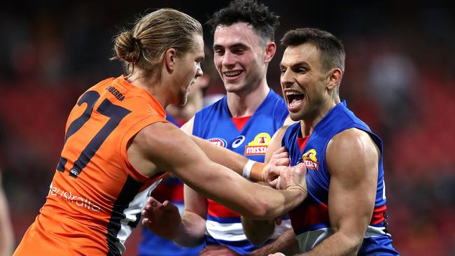 Harry Himmelberg gives Bulldogs forward Sam Lloyd a shove. Picture: Phil Hillyard