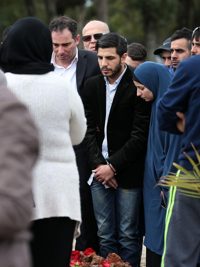 Jihad Dib (centre left) comforts his brother, champion boxer Billy Dib (centre right) at his wife Sara Selim Dib's grave.