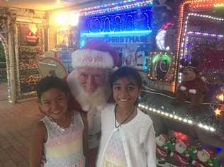 BRIGHT DISPLAY: Pat Kennedy at his Riverside Avenue home with visitors Aurora and Caitlyn O'Donoghue. Picture: Javier Encalada