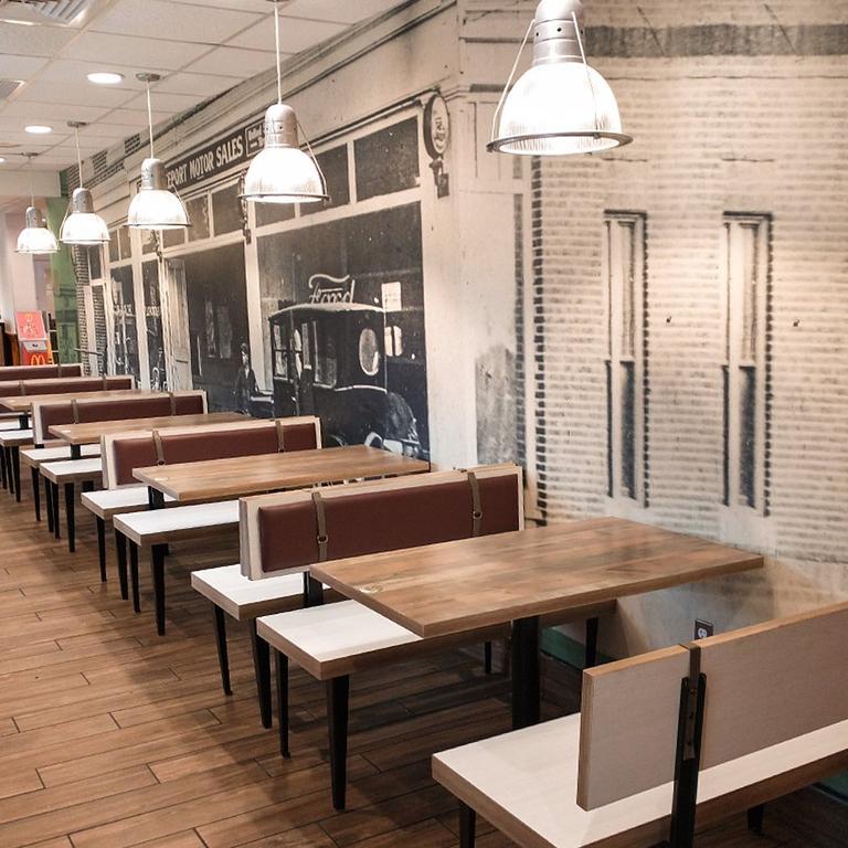 Inside are wooden booths and industrial lights as well as memorabilia. Picture: McDonald’s Corporation