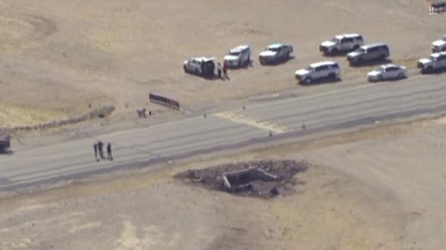 In this image taken from video, law enforcement at the site of a deadly plane crash at Marana Regional Airport after a deadly crash in Marana, Ariz., Wednesday, Feb 19, 2025. (KNXV via AP)