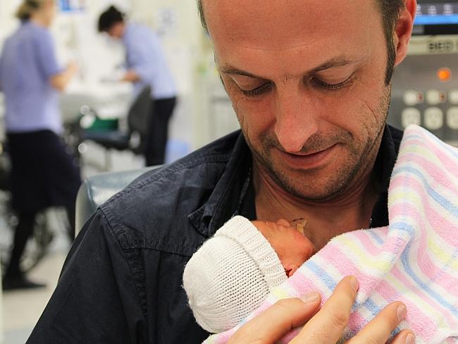 Rob’s first cuddle with Charlie at 2 days old in intensive care. 