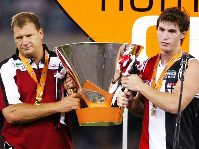 St Kilda coach Grant Thomas (left) and Lenny Hayes (right) reluctantly accept the enormous Wizard Home Loans Cup after defeating Geelong at Docklands. Picture: Michael Dodge