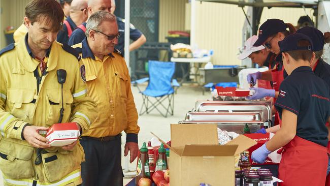 Volunteers of the Rapid Relief Team prepare food for fire crews in Wingello, in the Southern Highlands. Picture: Brett Hemmings/Getty Images