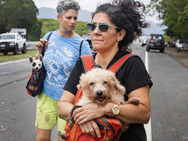 CAIRNS, AUSTRALIA, NewsWire Photos. DECEMBER 18, 2023: A Hoilloway Beach evacuee family and their pets   at the  Barron River bridge north Cairns after being rescued by boats following Cyclone Jasper Monday18th December 2023Picture: NCA NewsWire / Brian Cassey