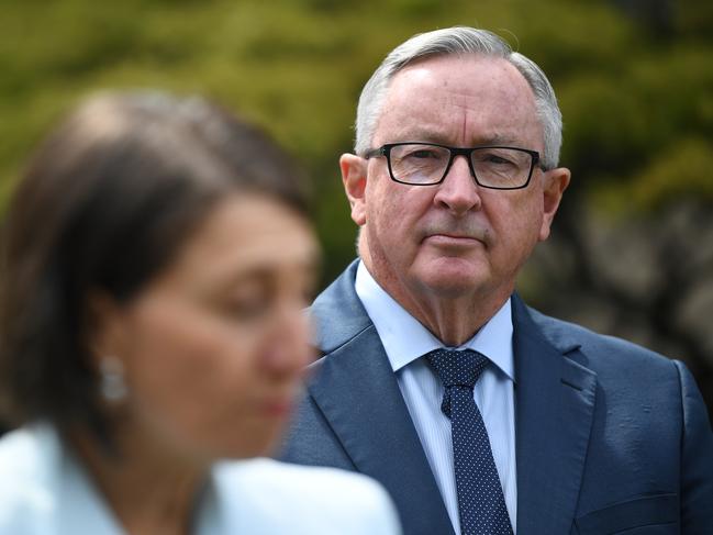 SYDNEY, AUSTRALIA - NewsWire Photos FEBRUARY, 10, 2021:NSW Health Minister Brad Hazzard watches on as  NSW Premier Gladys Berejiklian speaks to media at Parliament House in Sydney. Picture: NCA NewsWire/Joel Carrett