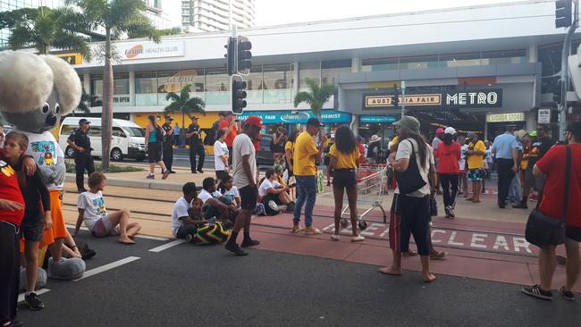 Stolenwealth Games protesters sit on tramlines blocking off Scarborough Street, Southport. Picture: Brianna Morris-Grant