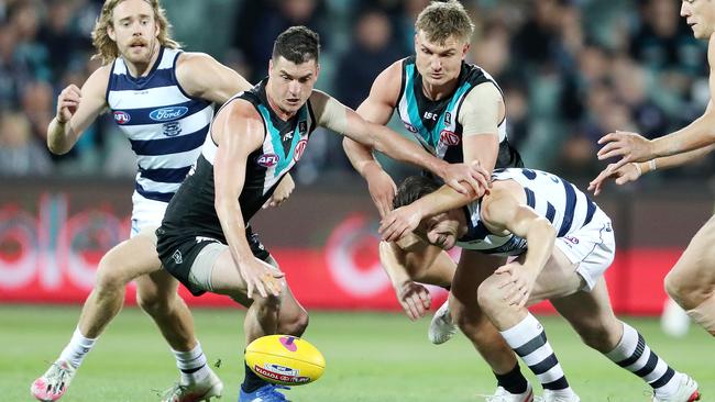 Tom Rockliff fights for the ball against Geelong’s Patrick Dangerfield in 2020.