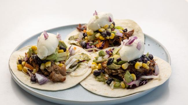 Pulled pork, black bean, avo, corn, sour cream and salsa verde tacos. Picture: David Kelly