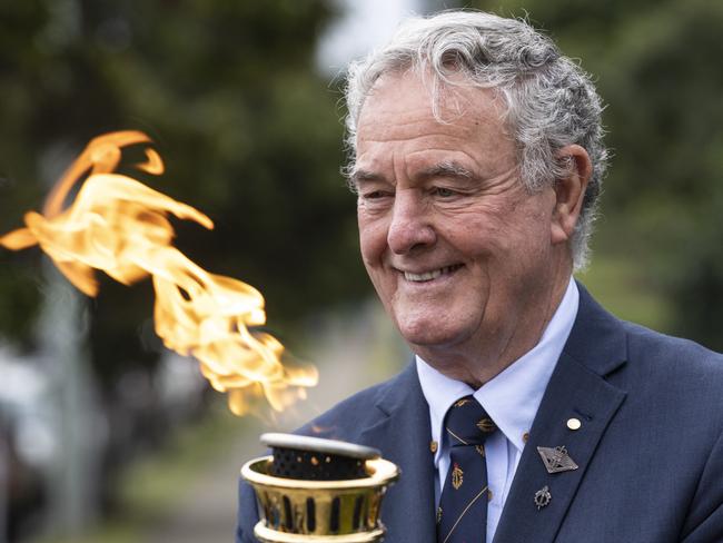 Legacy Australia chairman Eric Easterbrook with the Legacy Torch.