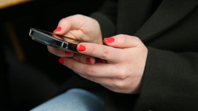 SYDNEY, AUSTRALIA - Newswire Photos - JULY 25 2023: People are seen on their mobile phones during lunch time in the Sydney CBD. Picture: NCA Newswire / Gaye Gerard