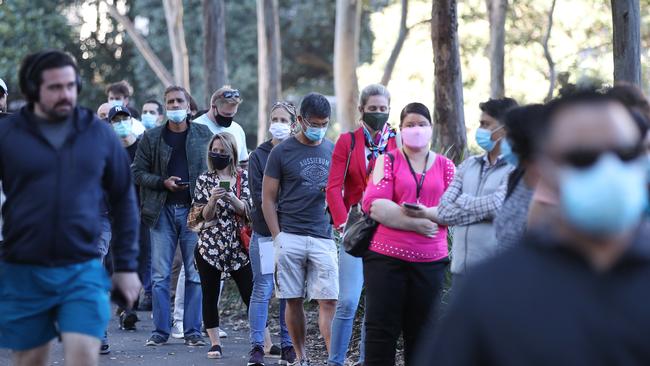 People lined up around the block outside the centre to get their shots. Picture: David Swift