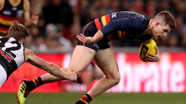 Bryce Gibbs of the Crows is tackled by Tom Jonas of the Power. Picture: James Elsby/AFL Media/Getty Images