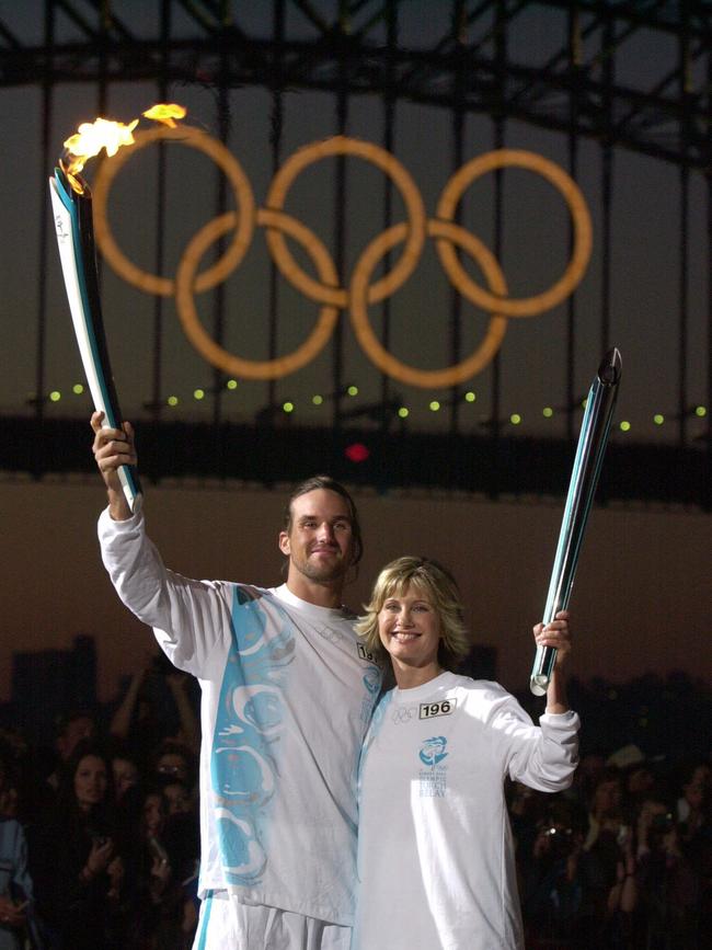 Torchbearers: Tennis player Patrick Rafter with singer Olivia Newton-John.