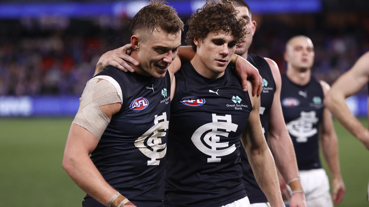 MELBOURNE, AUSTRALIA - JULY 13: Patrick Cripps and Charlie Curnow of the Blues embrace after the round 18 AFL match between Western Bulldogs and Carlton Blues at Marvel Stadium, on July 13, 2024, in Melbourne, Australia. (Photo by Darrian Traynor/AFL Photos/via Getty Images)