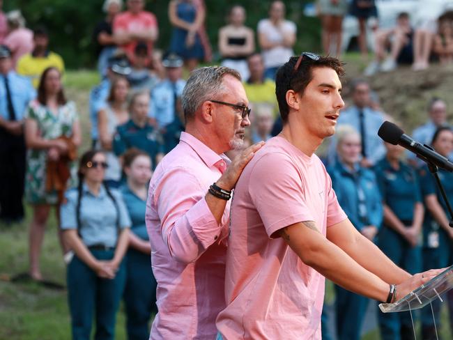 Hannah Clarke’s brother Nathaniel Clarke is supported by dad Lloyd during his speech at the vigil for her and her three children Aaliyah, 6, Laianah, 4, and Trey, 3, at Bill Hewitt Reserve in Brisbane. (AAP Image/Sarah Marshall)