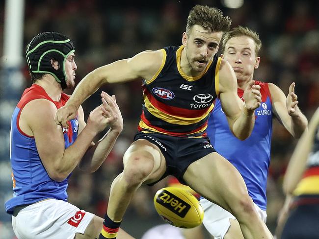 28/07/18 - AFL - Round 19 - Adelaide Crows v Melbourne at the Adelaide Oval. Jordan Gallucci plays tunnel ball with the ball between Angus Brayshaw and Bernie Vince. Picture SARAH REED