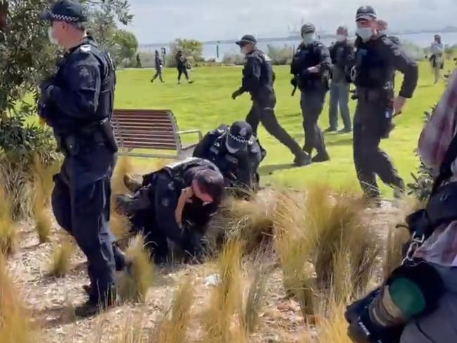 Riot police officers pin down a man. Picture: Olivia Jenkins