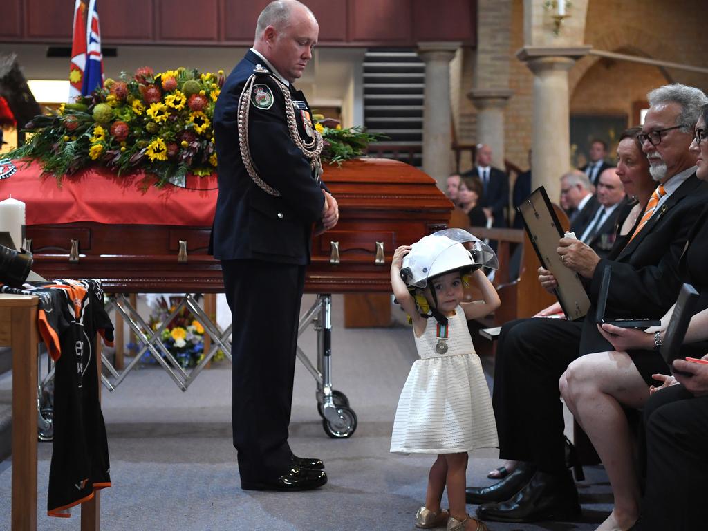 RFS Commissioner Shane Fitzsimmons at the funeral of volunteer firey Andrew O’Dwyer whose little girl Charlotte wears his helmet on Tuesday, January 7. Picture: Dean Lewins-Pool/Getty