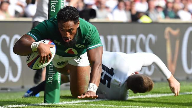 Ireland centre Bundee Aki dives over the line to score a try at Twickenham Stadium.