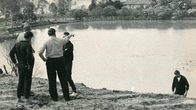 Police search the quarry waterhole on Upper Kedron Rd in Brisbane’s north.