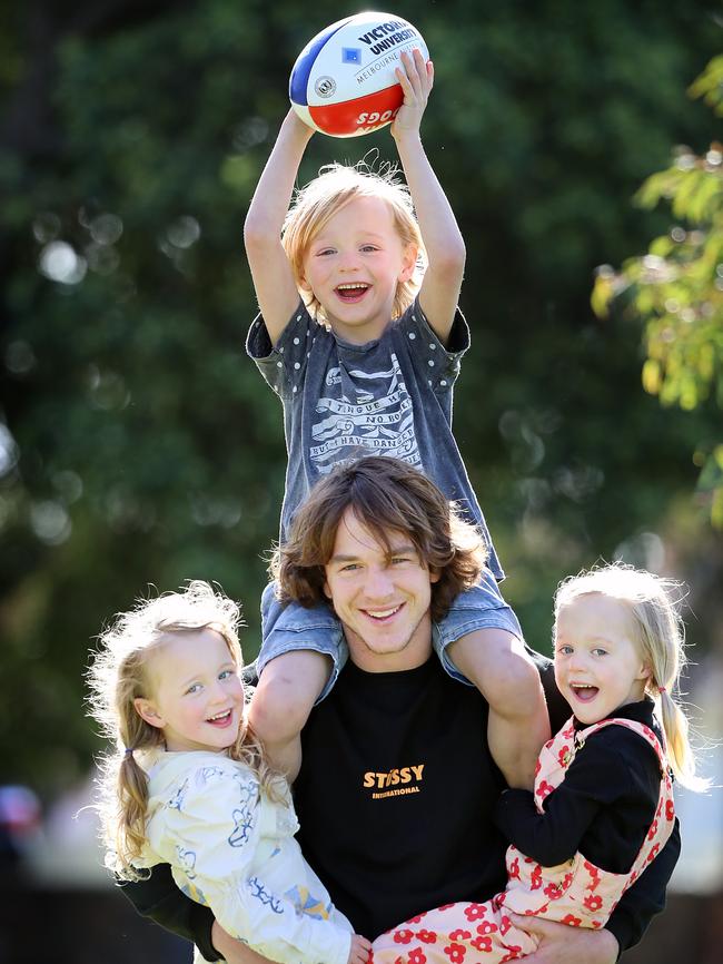 Western Bulldogs AFL player Liam Picken and his three kids celebrating Father's Day. Malachy, 6, on his shoulders, Delphine, 4, on the left, and Cheska, 4, on his right. Picture: Alex Coppel