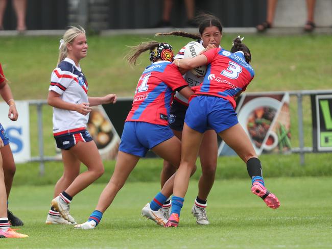 Mia Vaotuua is hit hard by Lily Porter and Dior O’Davis. Picture: Sue Graham