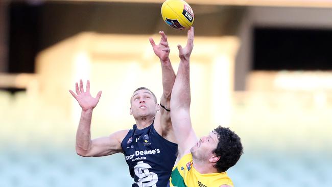 Alex Cailotto battles Eagles big Jarrad Redden in the ruck. Picture: Sarah Reed