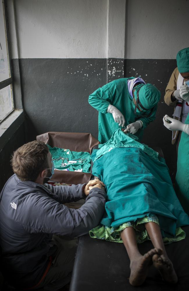 Joel Edgerton watches a trachoma surgery and offers a comforting hand. Picture: Michael Amendolia/Fred Hollows Foundation