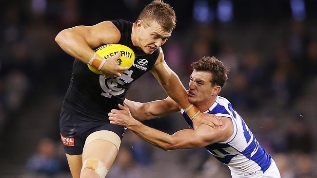 Patrick Cripps tries to break through a Kayne Turner tackle.