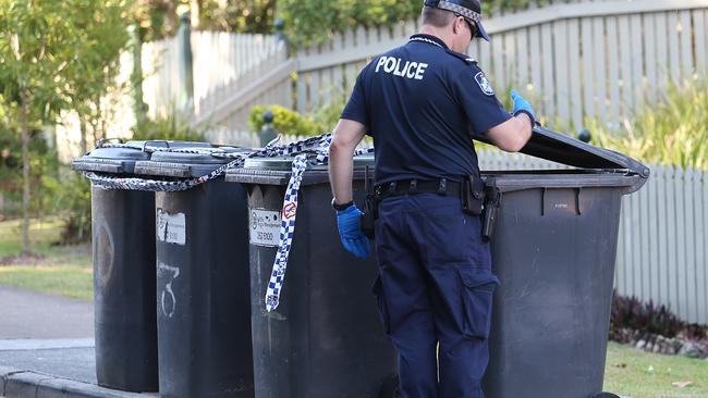 Queensland Police and forensic team scour the area around a unit complex. Pictures: Jack Tran