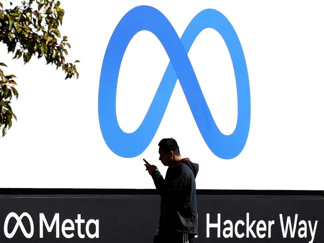 (FILES) In this file photo taken on October 28, 2021 a pedestrian walks in front of a new logo and the name 'Meta' on the sign in front of Facebook headquarters in Menlo Park, California. - Facebook's parent company Meta said February 25, 2022 that Russia will hit its services with restrictions after the social media giant refused authorities' order to stop fact-checkers and content warning labels on its platforms. (Photo by JUSTIN SULLIVAN / GETTY IMAGES NORTH AMERICA / AFP)