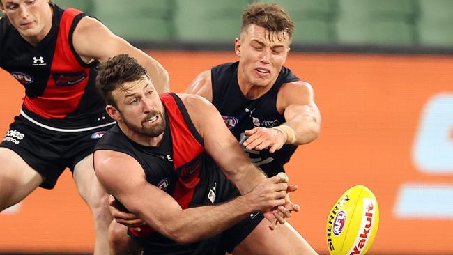 AFL Round 4.  Essendon v Carlton at the MCG. 27/06/2020.  Cale Hooker of the Bombers clears infant of Patrick Cripps of the Blues    . Pic: Michael Klein