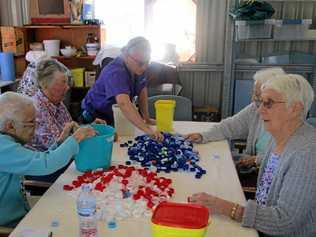 SORT IT OUT: Residents of Murroona Gardens have got behind the movement and are helping sort lids into colours.