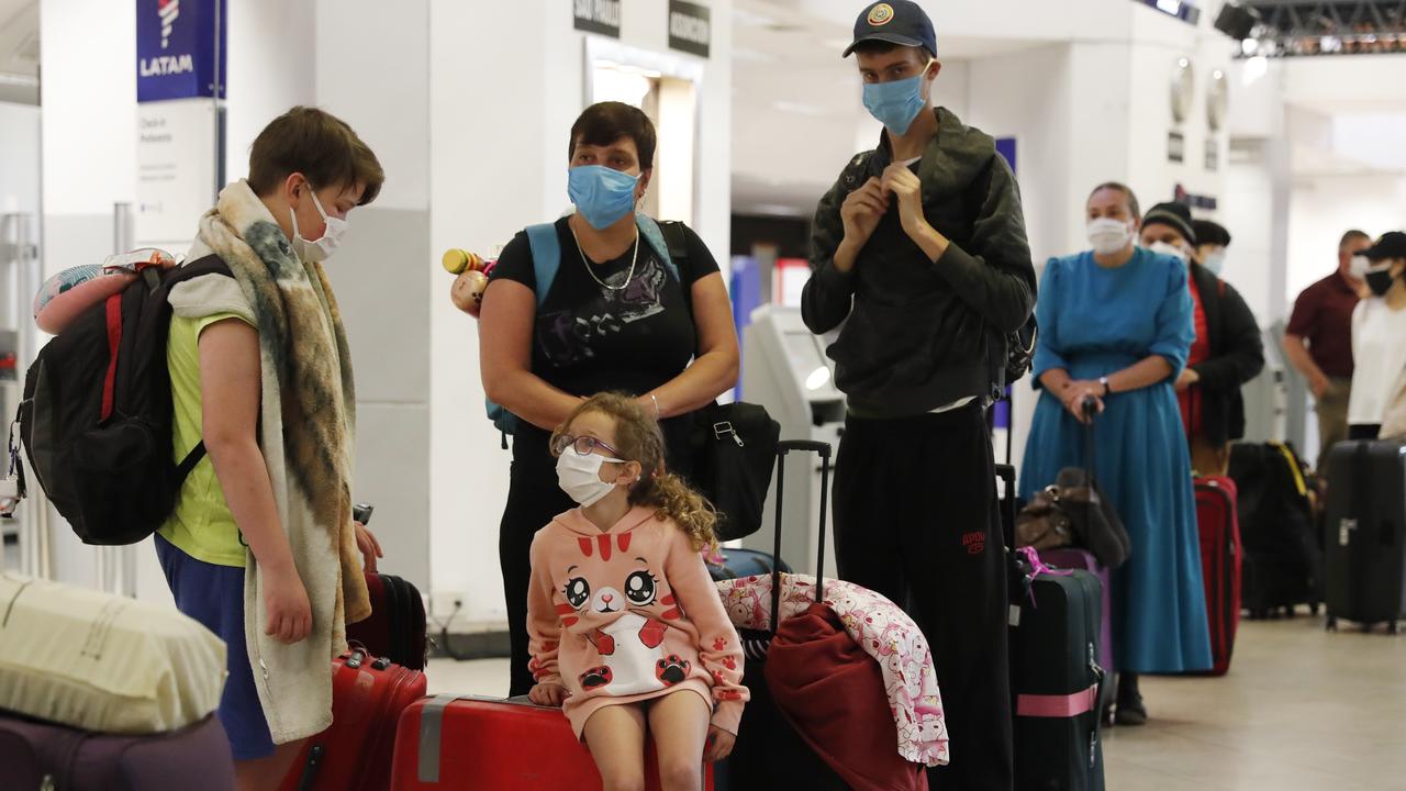 A family waits for a flight to Miami, Florida, from Silvio Pettirossi airport in Luque, Paraguay on Thursday, April 23, 2020. Paraguay's government has organised with several other nations to get their nationals home, amid a lack of flights. Picture: Jorge Saenz/AP