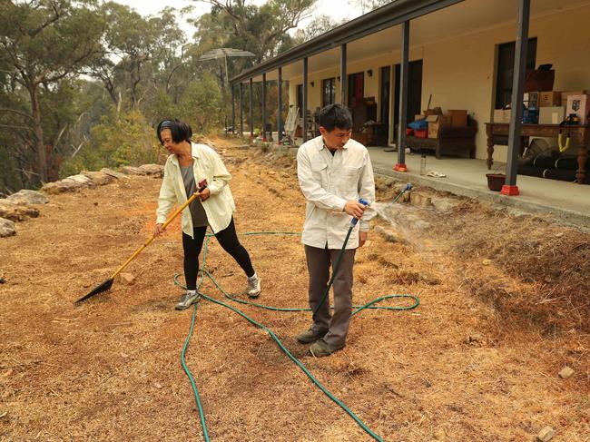 The Cams on Friday December 20 preparing to defend their home before the Green Wattle Creek fire worsened. Picture Rohan Kelly