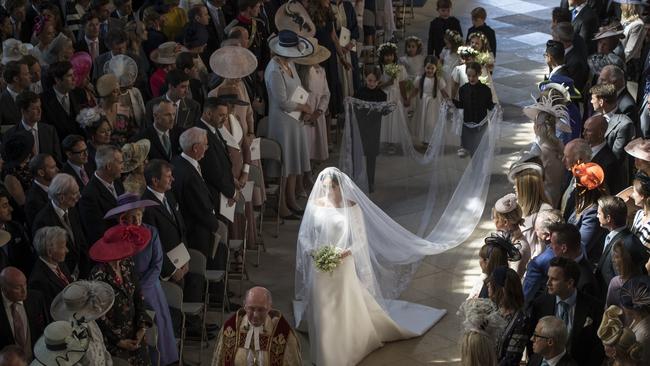 Meghan Markle walking down the aisle alone.