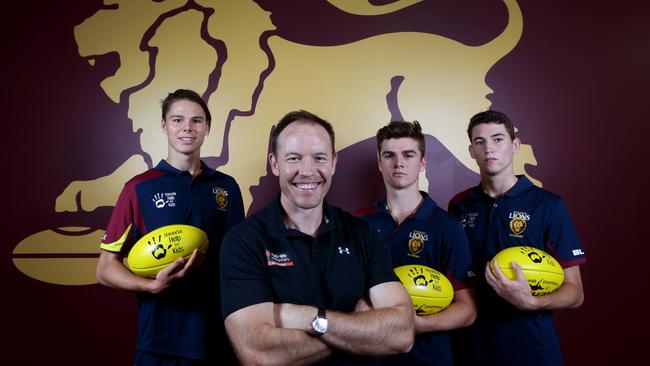 AFL Academy coach Brenton Sanderson with Lions academy players (from left) Eric Hipwood, Ben Keays and Jacob Allison. Picture: Darren England