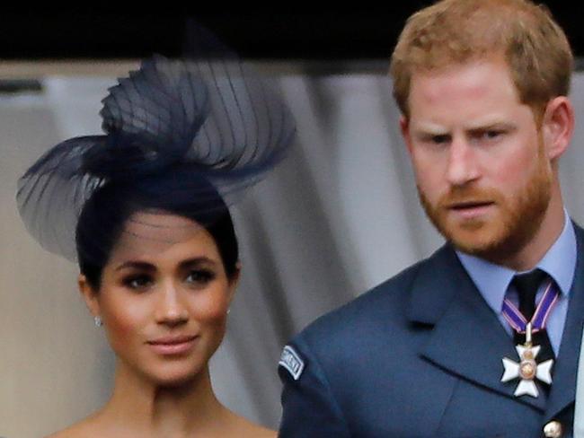 (FILES) In this file photo taken on July 10, 2018 (L-R) Britain's Camilla, Duchess of Cornwall, Britain's Queen Elizabeth II, Britain's Meghan, Duchess of Sussex, Britain's Prince Harry, Duke of Sussex, and Britain's Prince William, Duke of Cambridge come onto the balcony of Buckingham Palace to watch a military fly-past to mark the centenary of the Royal Air Force (RAF). - Britain's Prince Harry and his wife Meghan will give up their titles and stop receiving public funds following their decision to give up front-line royal duties, Buckingham Palace said on January 18, 2020. "The Sussexes will not use their HRH titles as they are no longer working members of the Royal Family," the Palace said, adding that the couple have agreed to repay some past expenses. (Photo by Tolga AKMEN / AFP)