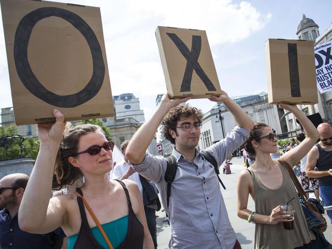 Anti-austerity demonstrators spell out the word "OXI" meaning "NO" in Greek at a rally in Trafalgar Square in central London. Picture: JACK TAYLOR