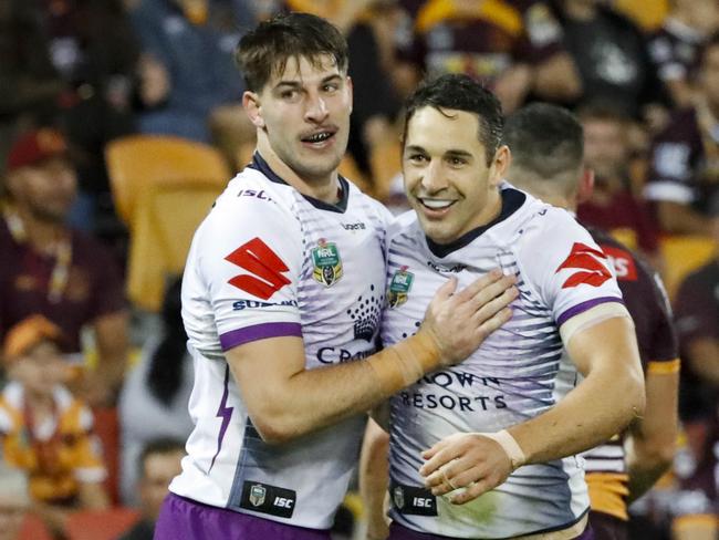 Billy Slater celebrates with team mates after scoring a try.