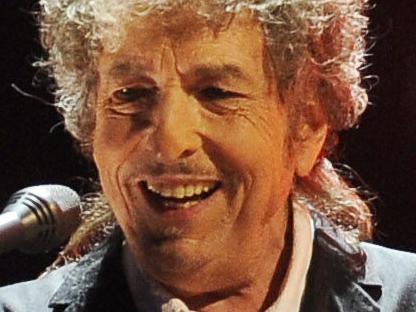 FILE - In this Jan. 12, 2012, file photo, Bob Dylan performs in Los Angeles. Dylan, who was named the winner of the 2016 Nobel Prize in literature on Oct. 13, 2016, says he â€œabsolutelyâ€ wants to attend the Nobel Prize Award Ceremony â€œif itâ€™s at all possibleâ€ in December, finally breaking his silence about earning the prestigious honor. (AP Photo/Chris Pizzello, File)